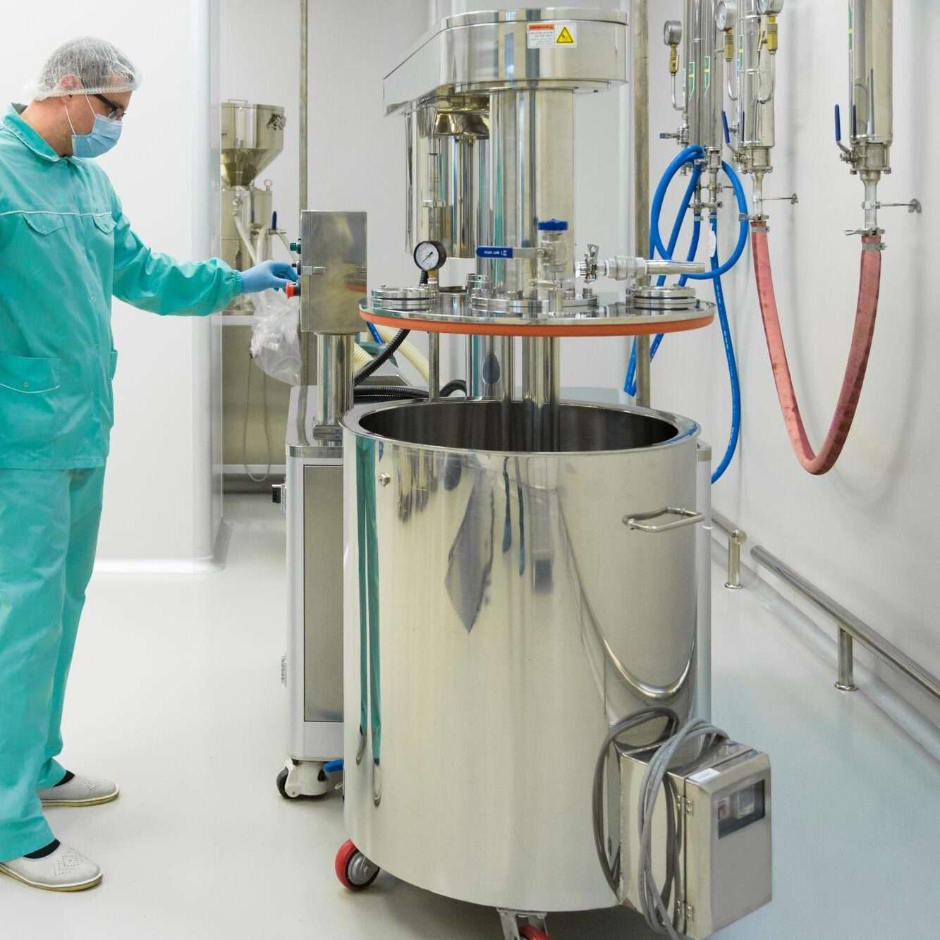 pharmaceutical-factory-man-worker-protective-clothing-working-with-control-panel-sterile-working-conditions_645730-287