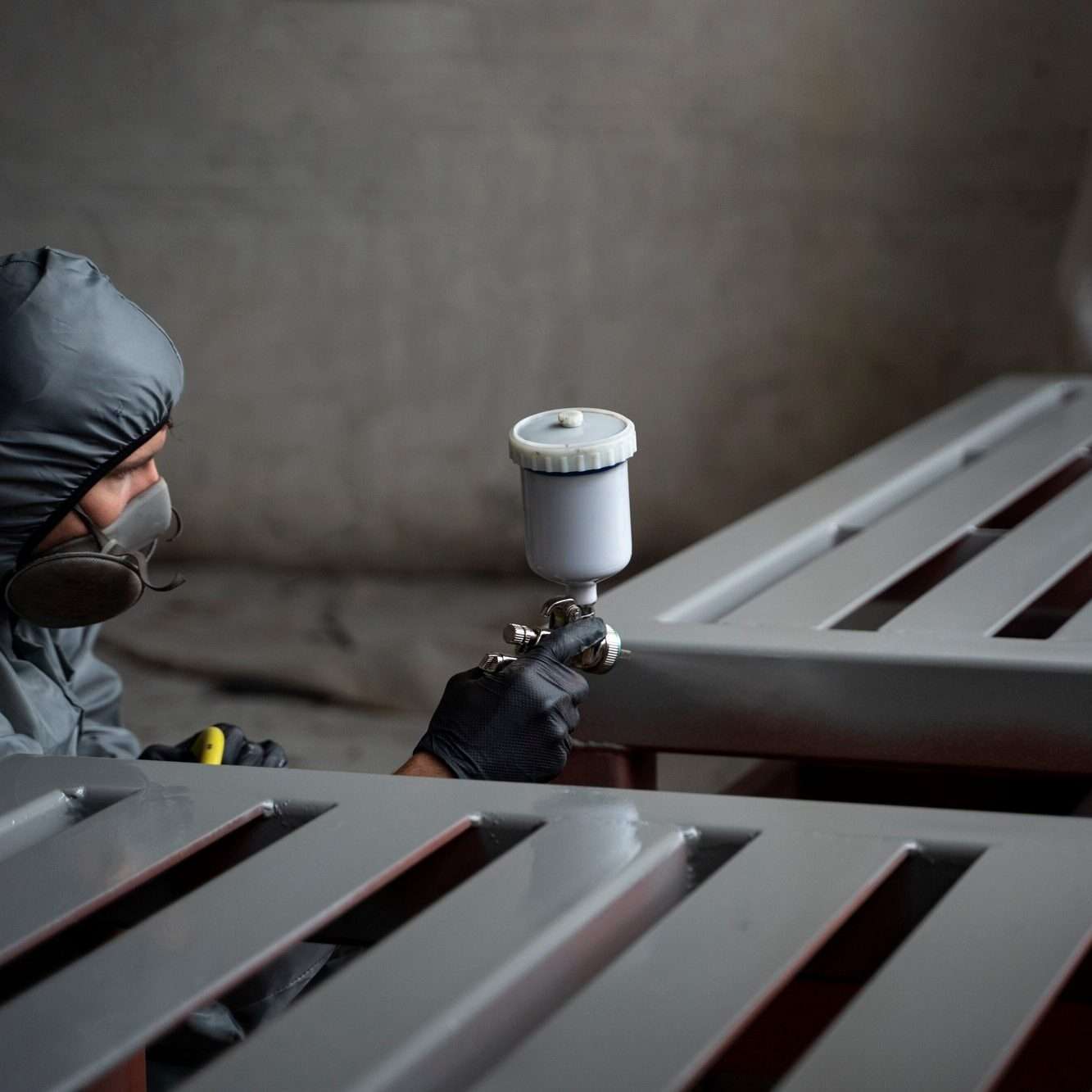 side-view-man-spraying-powder-paint-from-gun_23-2149878773